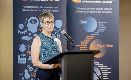 Professor Janeen Baxter Professor Janeen Baxter standing smiling at a podium